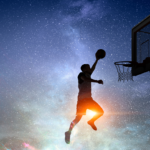 A silhouette of person jumping in the air shooting a basketball.