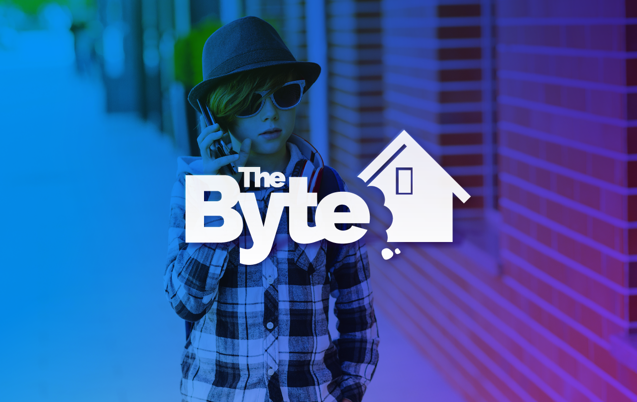A kid with sun glasses and a fedora. With the BYTE logo in front of it.
