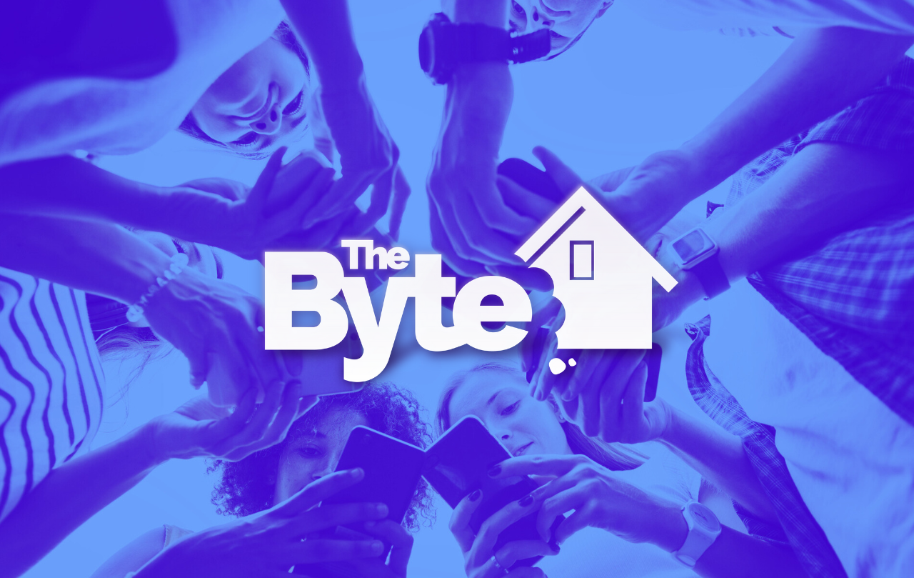 A close-up image looking up a group of people's hands on their phones. The color blue and the BYTE logo is overlayed on top of the image.